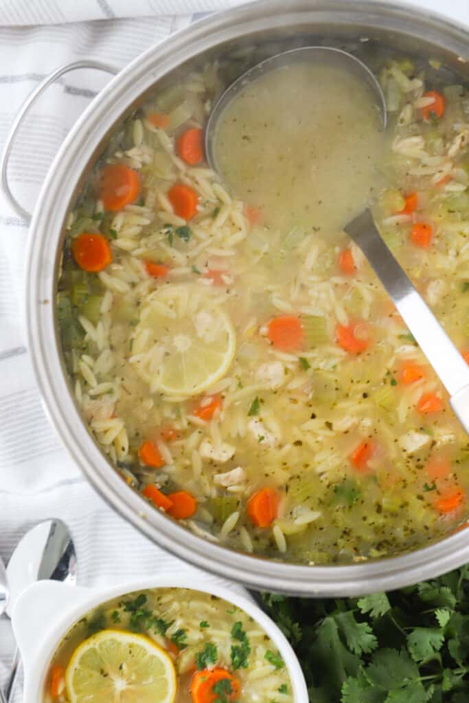 A pot of greek lemon chicken soup with orzo.