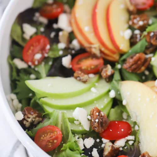 leafy green salad with a white bowl