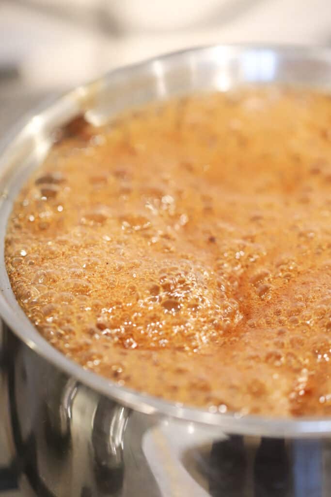 honey glaze sauce recipe for ham boiling in a pot.