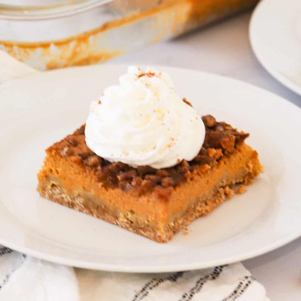 A square of pumpkin pie with crunchy topping.