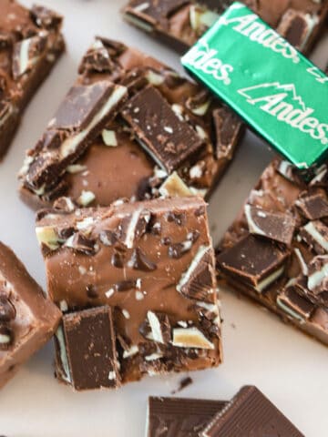andes mint fudge stacked in a pile with mints around