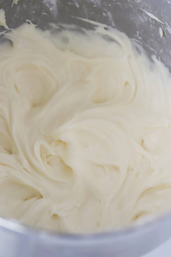 Whipped cream cheese frosting in a mixing bowl. An easy cream cheese frosting recipe.