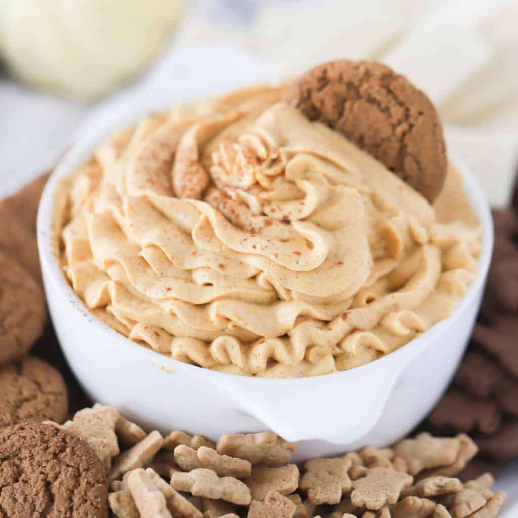 Pumpkin fluff in a white bowl with sweet crackers on a tray. pumpkin recipes for kids.