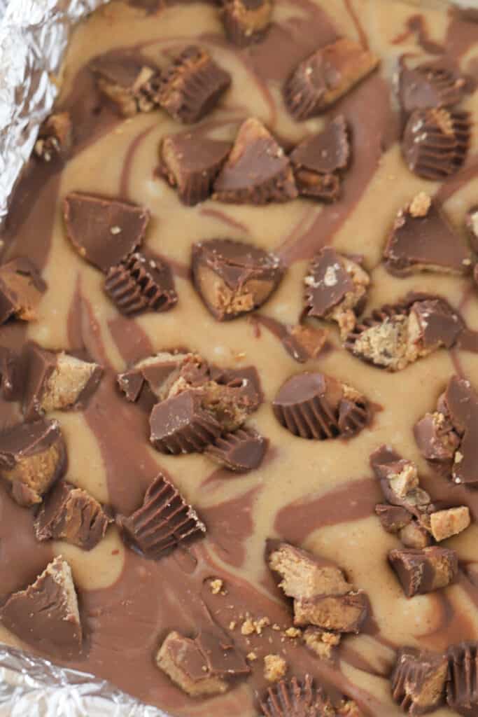 peanut butter fudge in a baking dish lined with foil