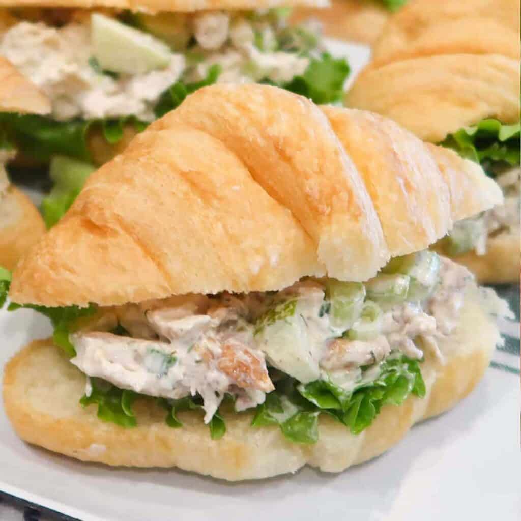Chicken Salad Sandwiches made on croissants and arranged on a serving platter.