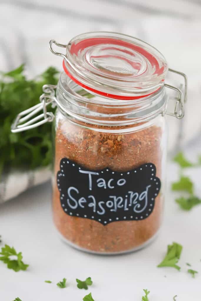 A mason jar full of Homemade Taco Seasoning. What's in taco seasoning, how to make taco seasoning, taco spices.