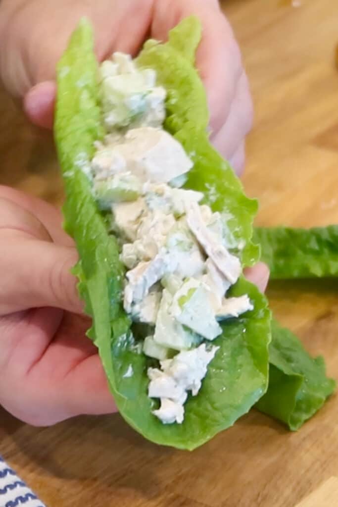 Chicken salad wrapped inside a large lettuce leaf.