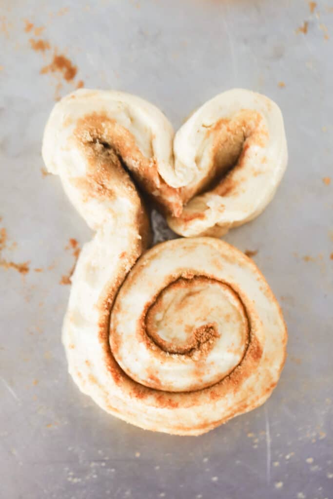 A bunny cinnamon roll shaped and ready to bake.