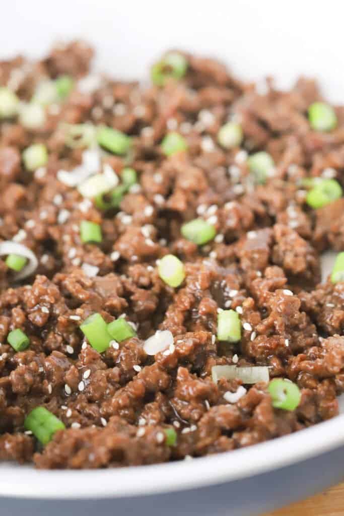 Korean Ground Beef in a large skillet topped with green onions and sesame seeds. Ground beef with soy sauce, ground beef and rice recipes.