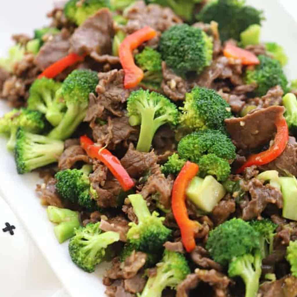 Homemade Teriyaki marinade for easy teriyaki beef and broccoli stir fry on a white plate served with rice, recipes with carne picada, beef teriyaki recipe.