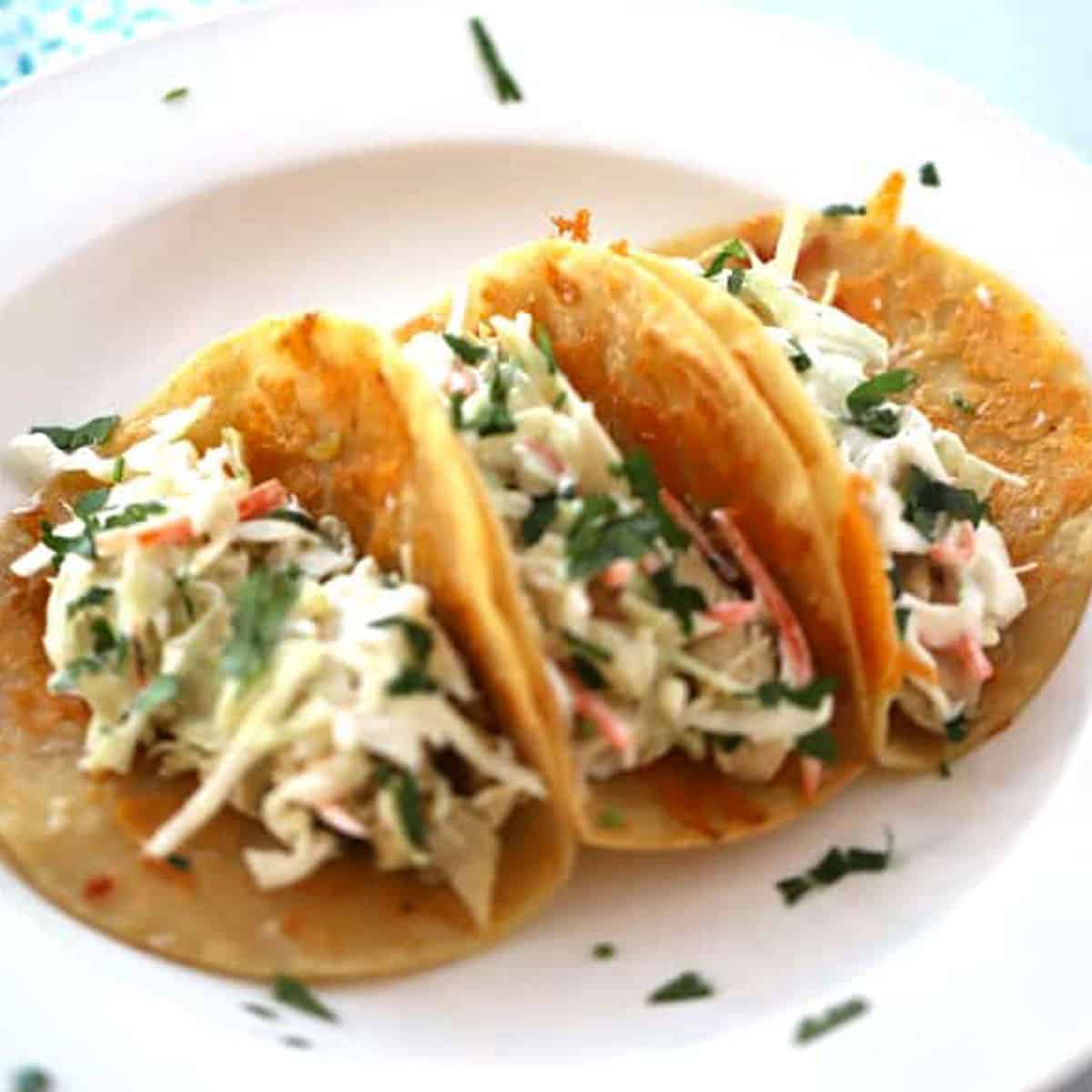 crockpot Cilantro Lime Chicken tacos are delicious on taco tuesday and the other 6 days of the week we wish were taco Tuesday! So delicious!