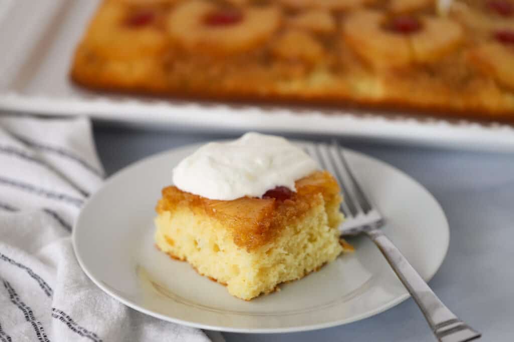 Old fashioned pineapple upside down cake on a white plate, caramel pineapple upside down cake, pineapple cake recipe, pineapple upside down cake yellow cake mix.