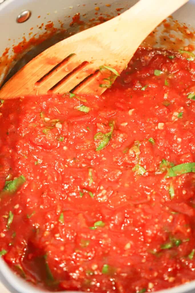 A close up of quick pizza sauce cooking in a pot.pizza sauce recipe easy, how to make homemade pizza sauce.