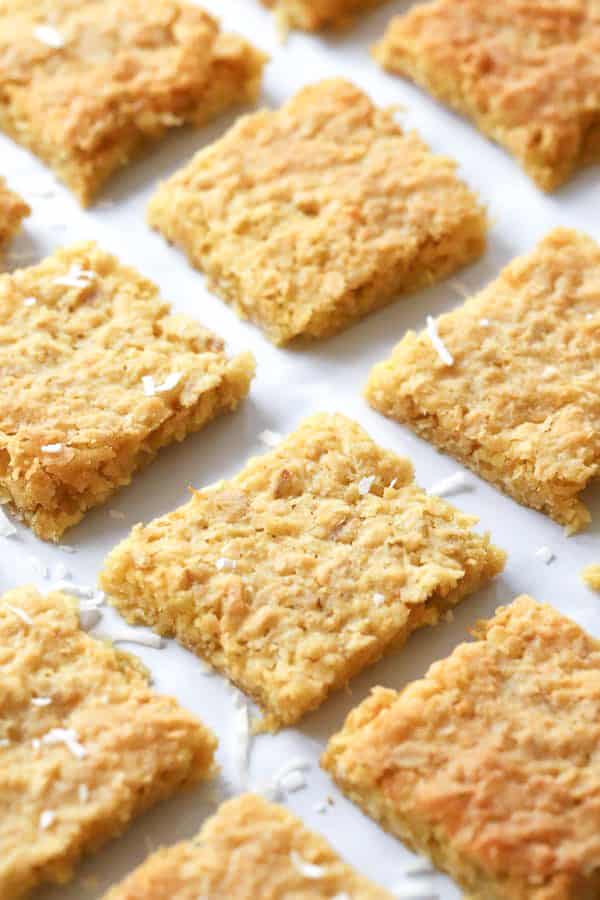 Coconut Cookie Bars cut into squares and lined up a baking sheet.