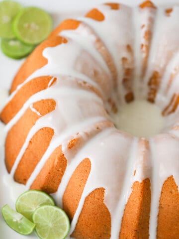 key lime pound cake recipe with limes on a serving platter
