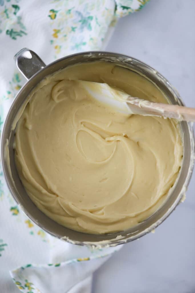A mixing bowl full of cake batter with a spatula in it. how to make pound cake. English Cake recipe. Pound Cake with Cream Cheese.
