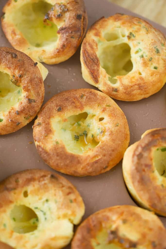 Freshly baked Cheddar Chive Popovers still inside the muffin tin.