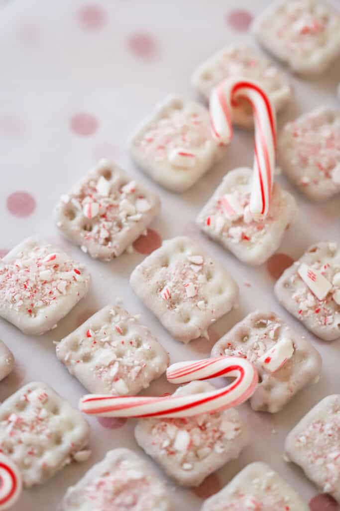 A tray of white chocolate dipped pretzels topped with crushed candy canes.