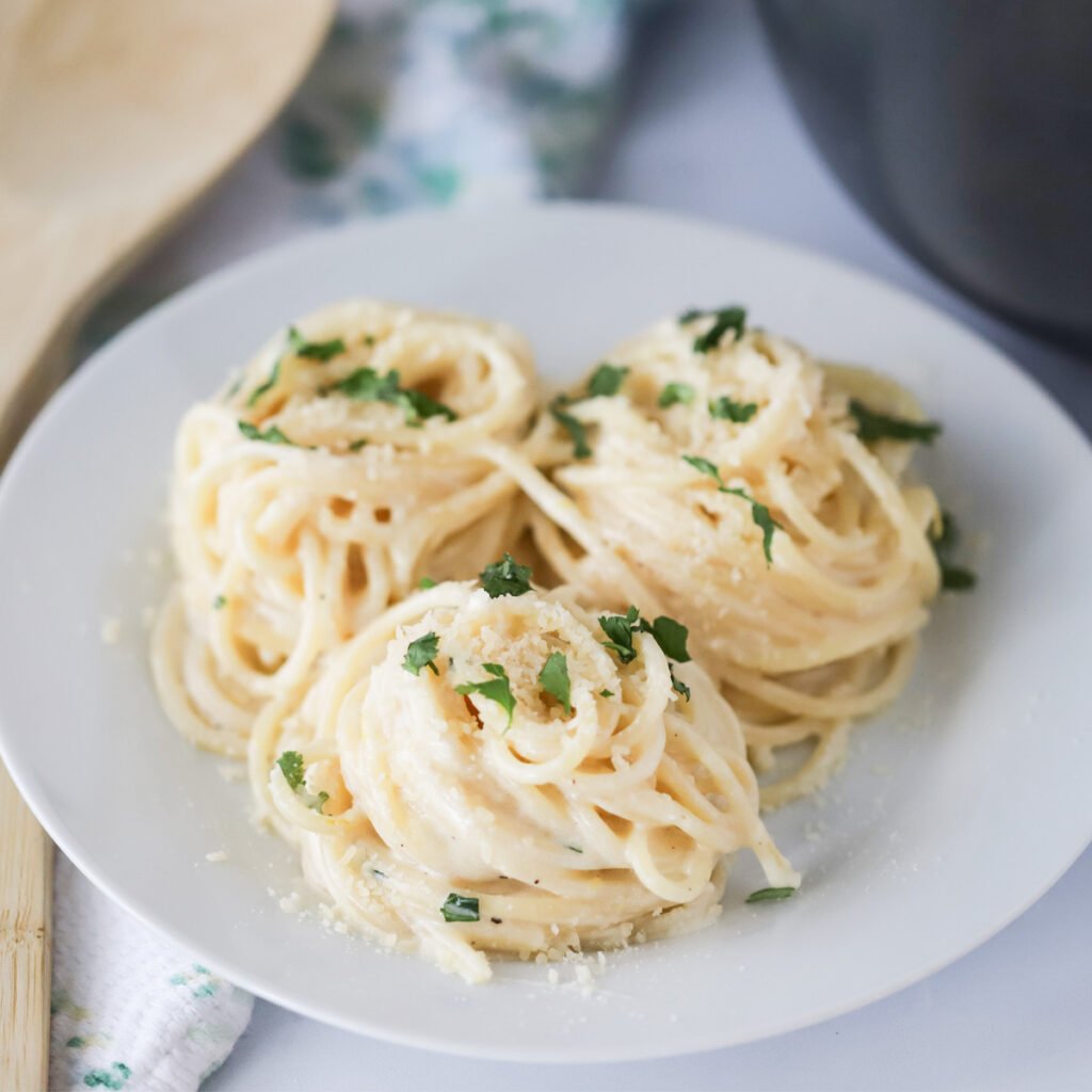 lemon cream sauce recipe on a white plate, garlic cream sauce for pasta, garlic cream sauce.