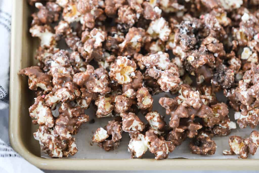 A baking sheet covered in Andes Mint Chocolate Popcorn, a great Christmas popcorn idea.