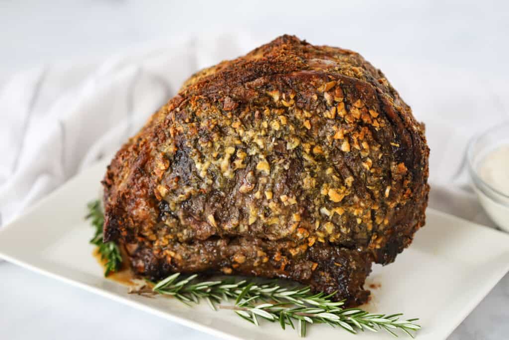 A large serving platter with a cooked Prime Rib Roast. what to serve with prime rib. 