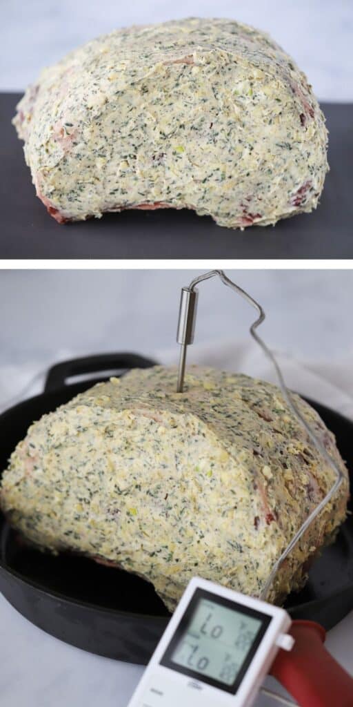 Prime Rib roast covered in herb butter with a thermometer inserted into the center. herb crusted prime rib. 