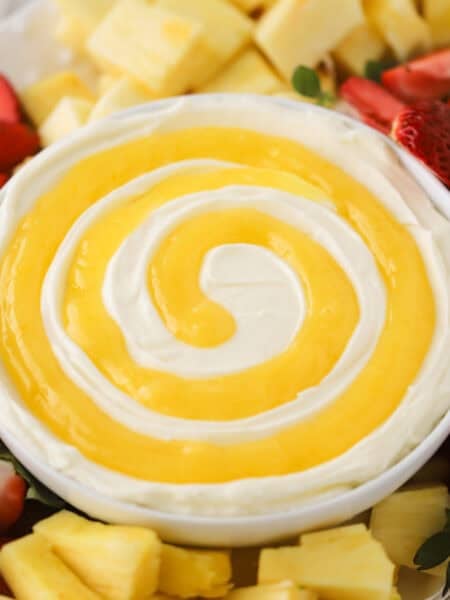 lemon Cheesecake Fruit dip on a platter wiith fresh strawberries and pineapple, best dip for fruit. lemon curd swirl on a lemon cheesecake fruit dip