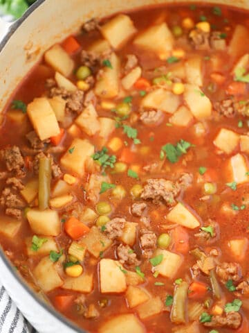vegetable beef soup recipe in a white pot, vegetable soup with ground beef, recipe vegetable beef soup.