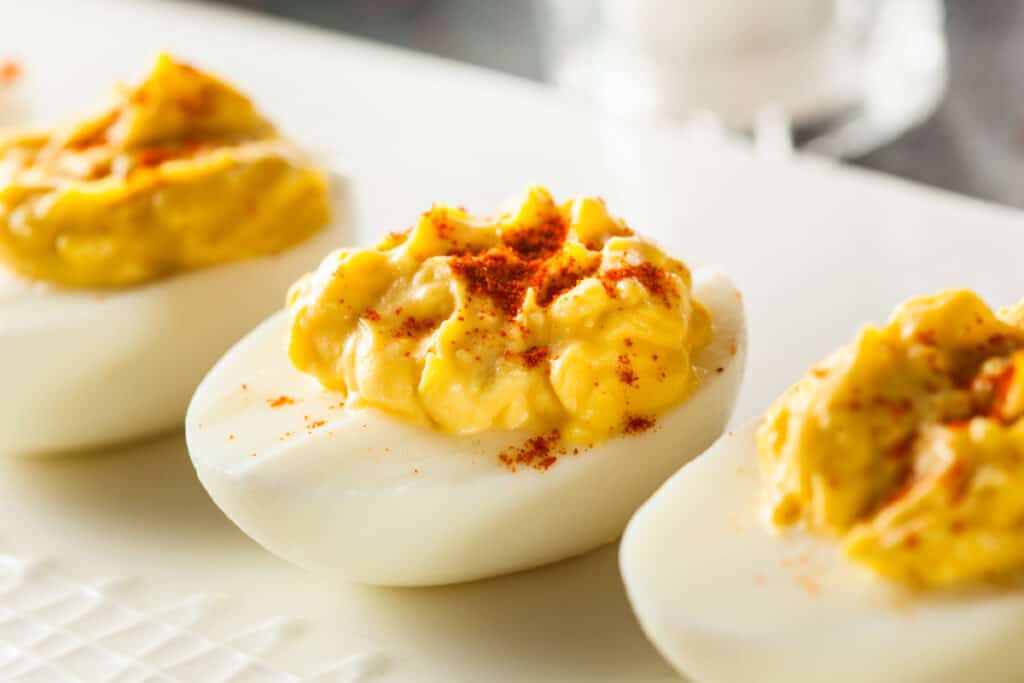 Classic Deviled Eggs on a serving platter; baby shower Deviled Eggs; best Deviled Eggs recipe.