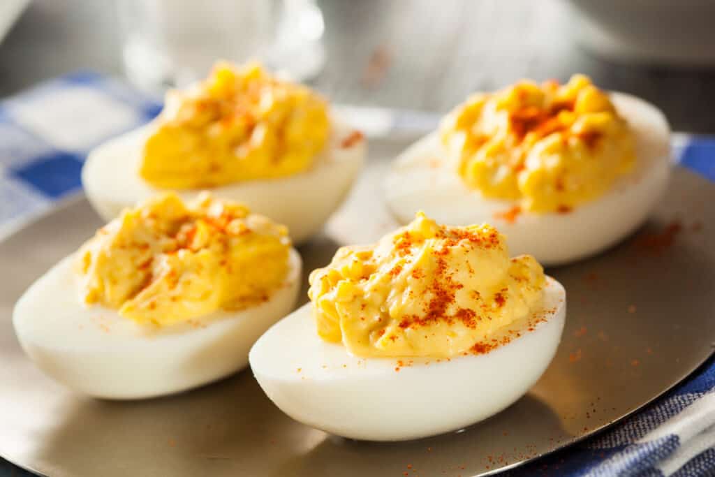 A serving platter serving up the best Deviled Egg recipe; baby shower Deviled Eggs.
