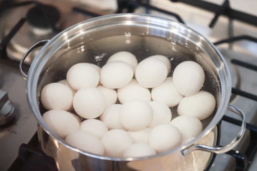 Eggs in a large pot reach to boil; hard boiled eggs baking soda method.