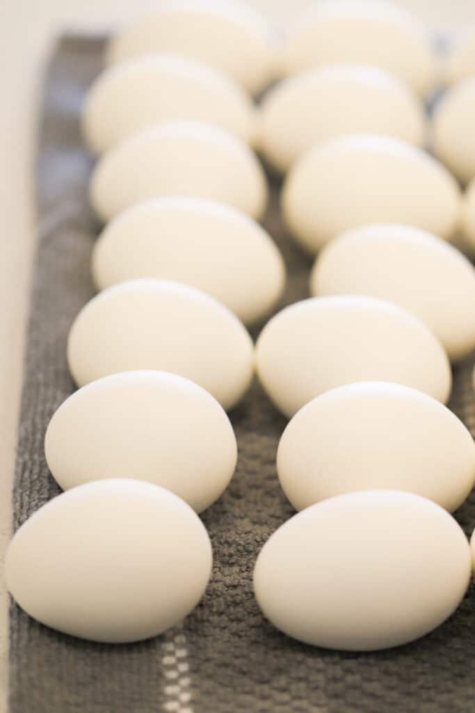 Hard boiled eggs on a cloth ready to dye eggs (food coloring method).