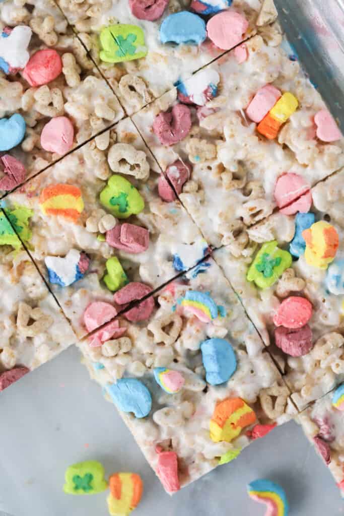 Lucky Charms No-Bake Cookie Bars cut into squares in a baking sheet.