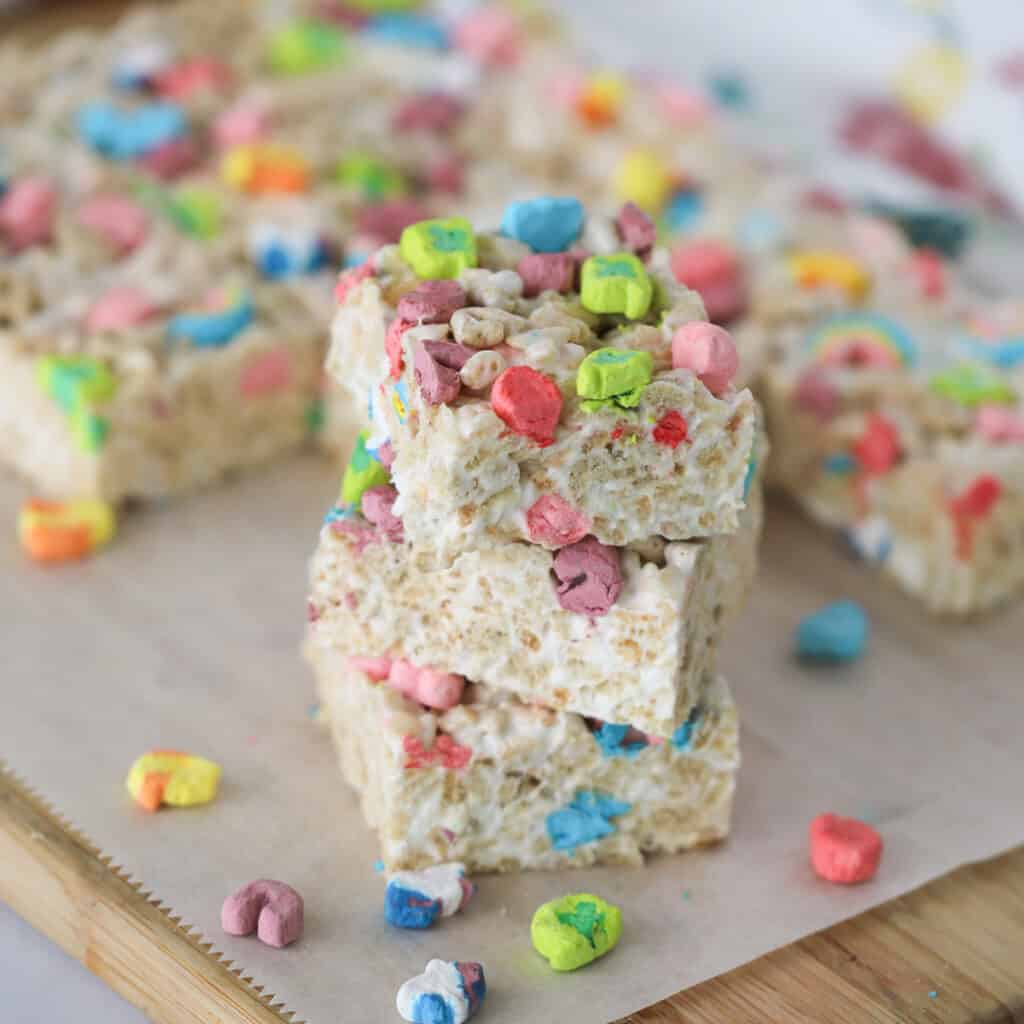 A stack of marshmallow cereal bars made with Lucky Charms.