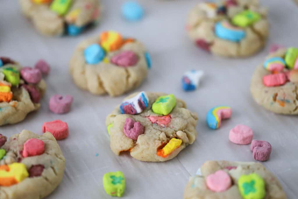 Lucky Charms Cookies on a baking sheet with parchment. Lucky charm cookie dough, lucky cookies.