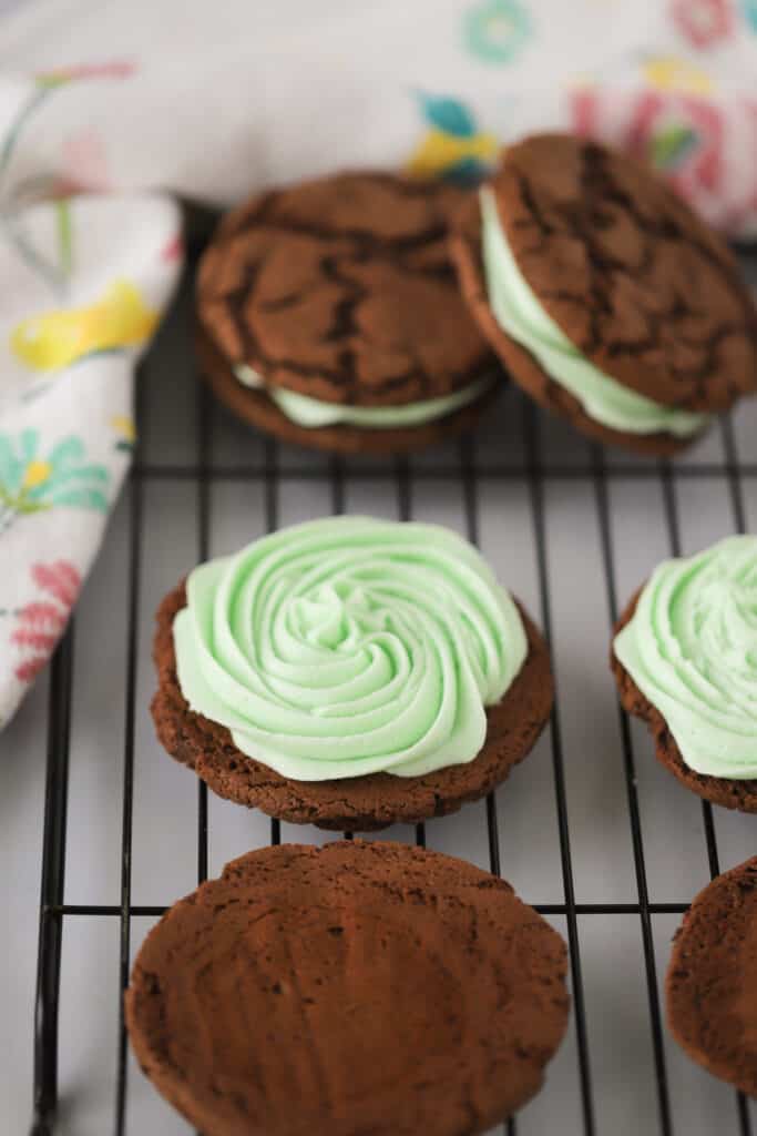 Homemade Mint Chocolate Oreos on a wire cooling rack.