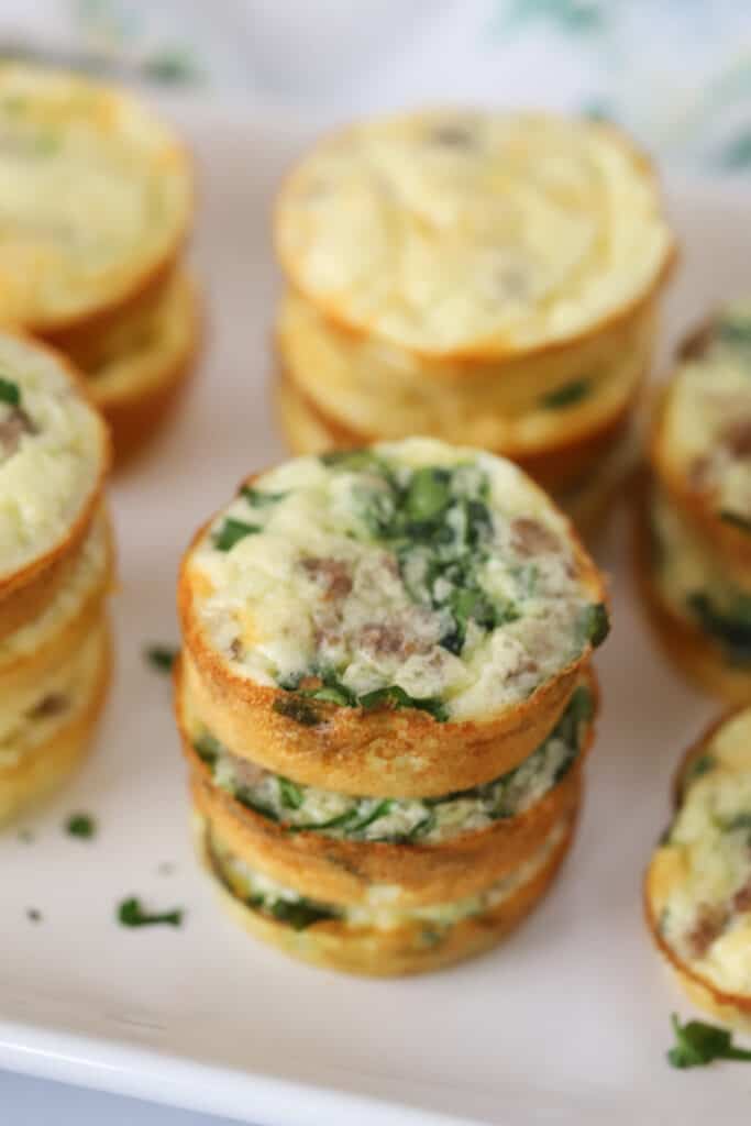 Protein Egg Bites with Cottage Cheese stacked on a serving plate, egg bites cotta cheese, spinach egg bites.