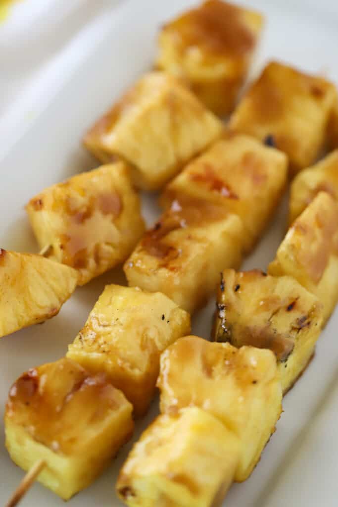 Grilled Pineapple kabobs with brown sugar glaze.  Grilled pineapple dessert. Glazed pineapple.