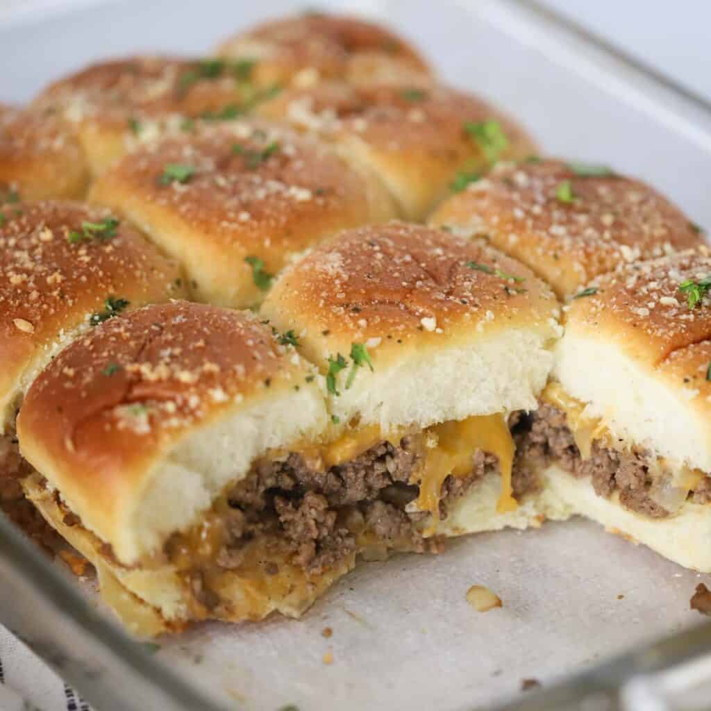 cheeseburger sliders on a baking sheet, an easy taylor swift superbowl party recipe.