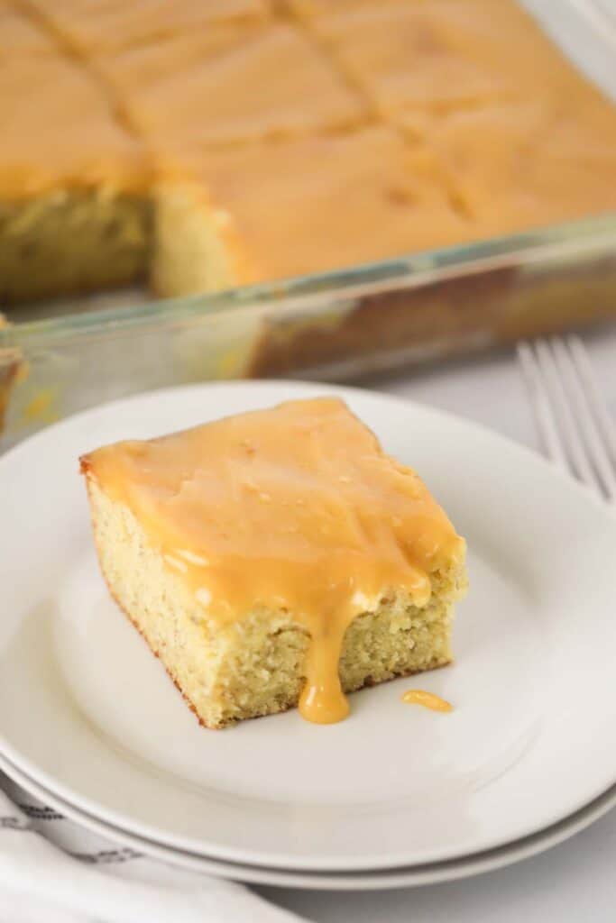 Best banana cake, this is an easy moist banana cake recipe that is covered with a layer of gooey caramel sauce.