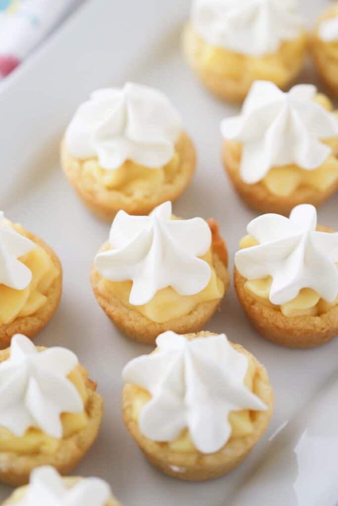 Banana cream pie cookies topped with whipped cream, easy cookie cups recipe.