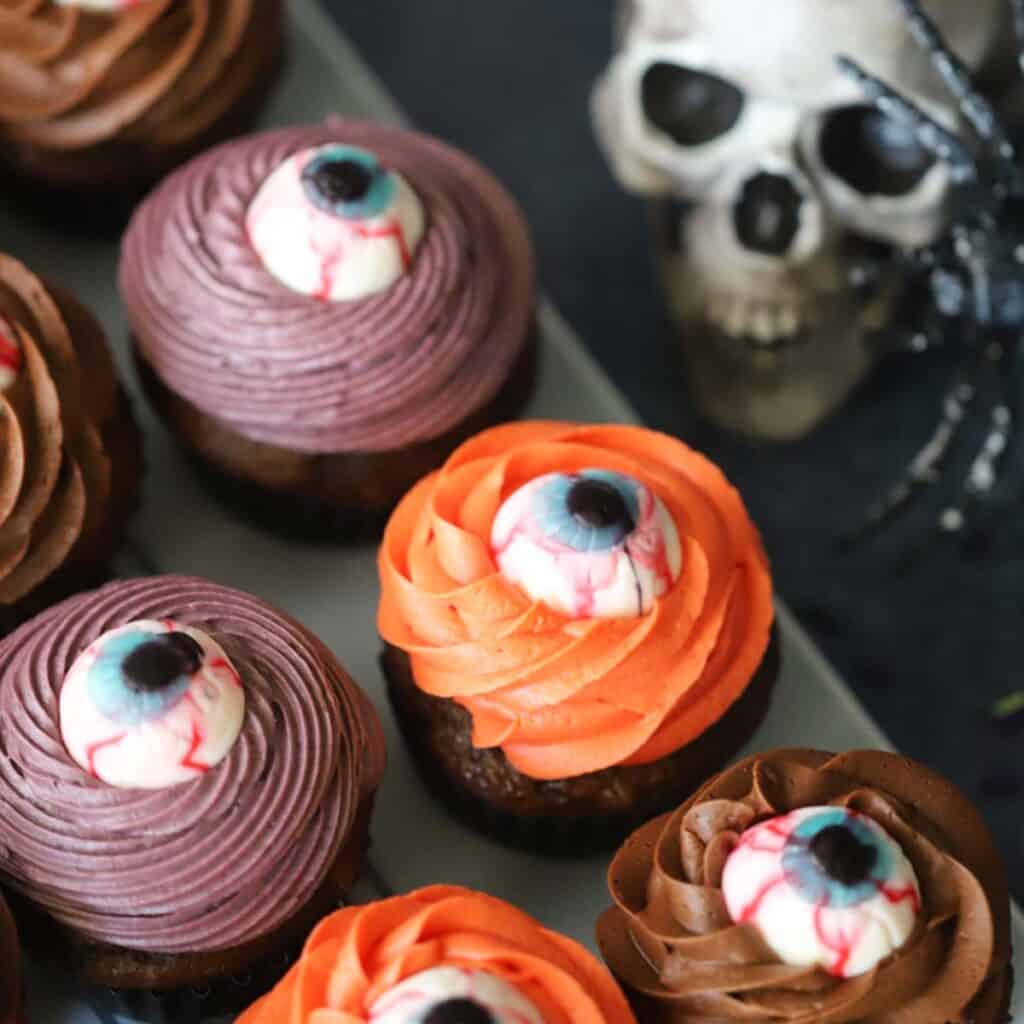 Cyclops cupcakes on a tray decorated for halloween