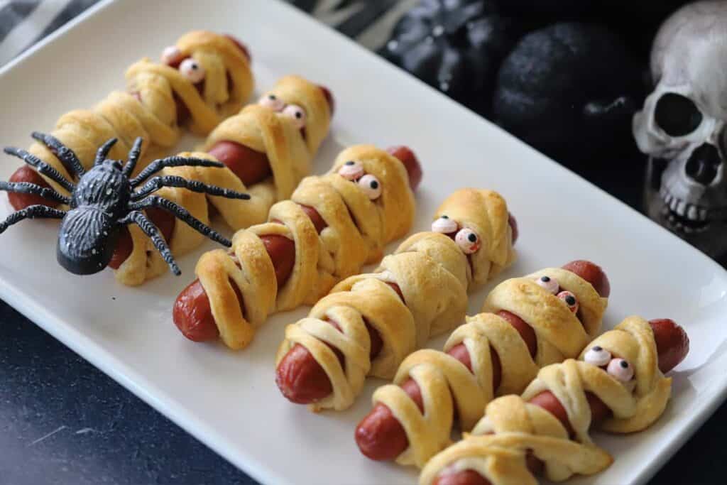Mummy hot dogs on a plate, mummy dogs, halloween dinner ideas.