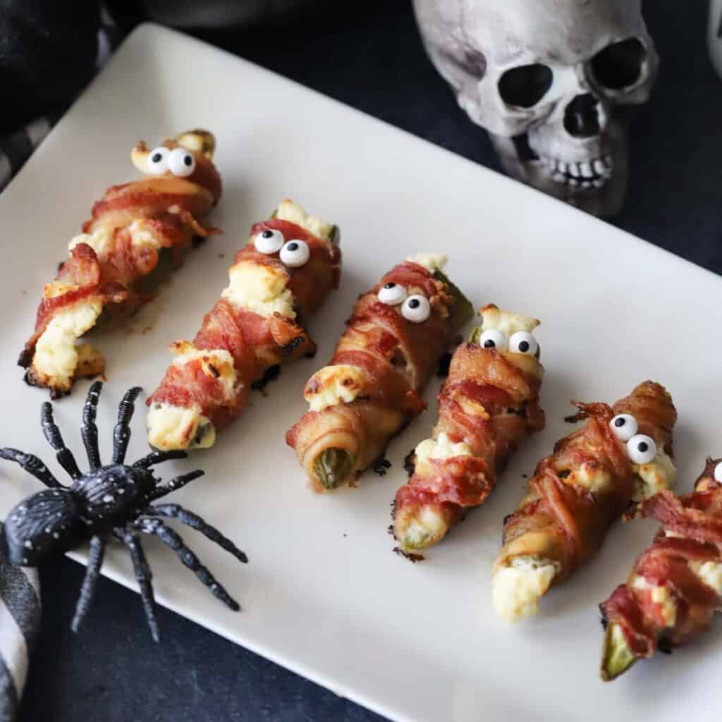 Halloween popper mummy appetizers on a plate.