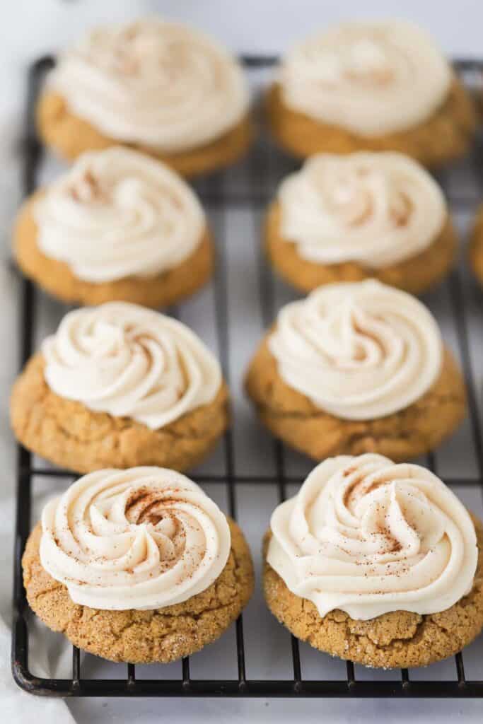 A tray full of pumpkin cookies with cream cheese frosting, a delicious soft pumpkin cookie.