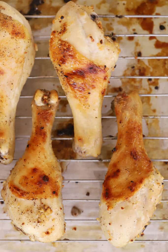 baked chicken legs on a wire rack, garlic parmesan chicken legs, baked chicken drumstick recipe. 
