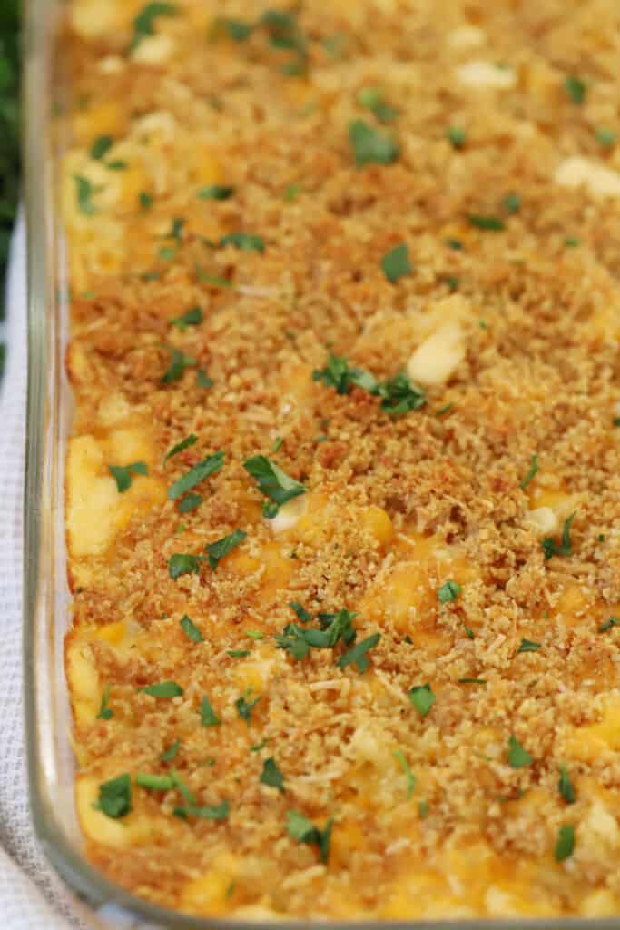 A baking dish full of our baked mac and cheese recipe with bread crumbs. It's the ultimate comfort food for people of all ages.