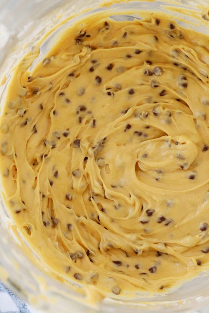 buckeye dip in a mixing bowl with mini chocolate chips, buckeye recipe with cream cheese, best cream cheese dip recipes.