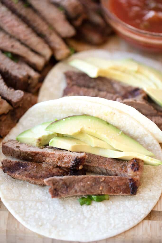 how to cook carne asada  the best carne asada tacos in corn tortilla shell with avocado.