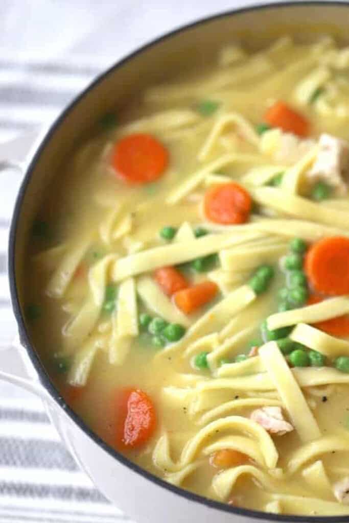 A large bowl full of homestyle chicken noodle soup. This homestyle chicken and noodles is the best soup for cold weather.